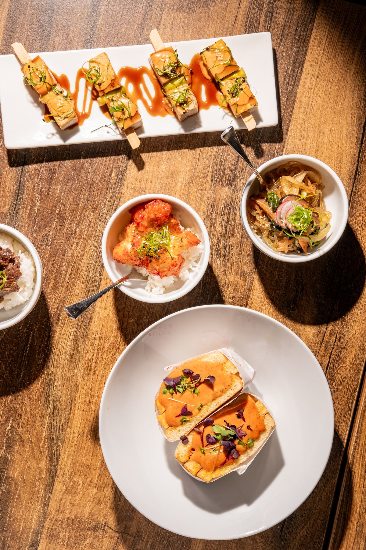 Sharing spread of canapés, bowls and skewers