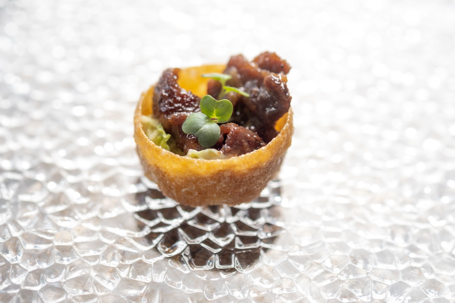 Bulgogi tartlet canapé on textured glass
