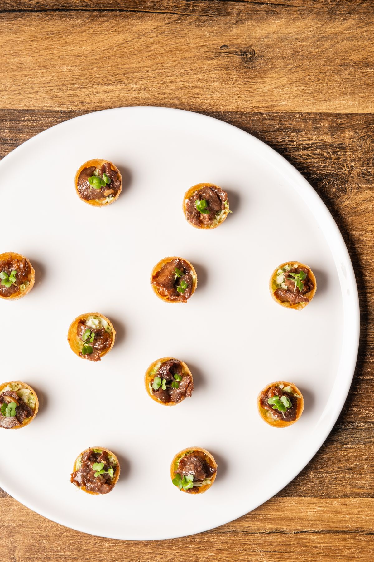 Bulgogi tartlet canapés on a white plate