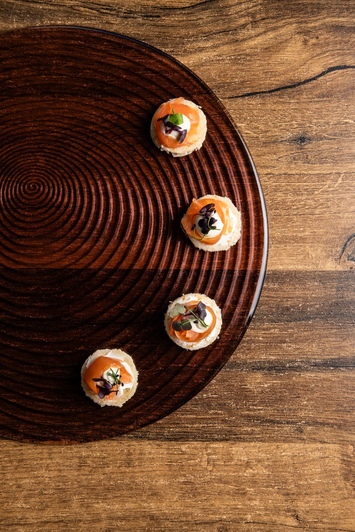 Salmon canapés on a lacquered tray from above