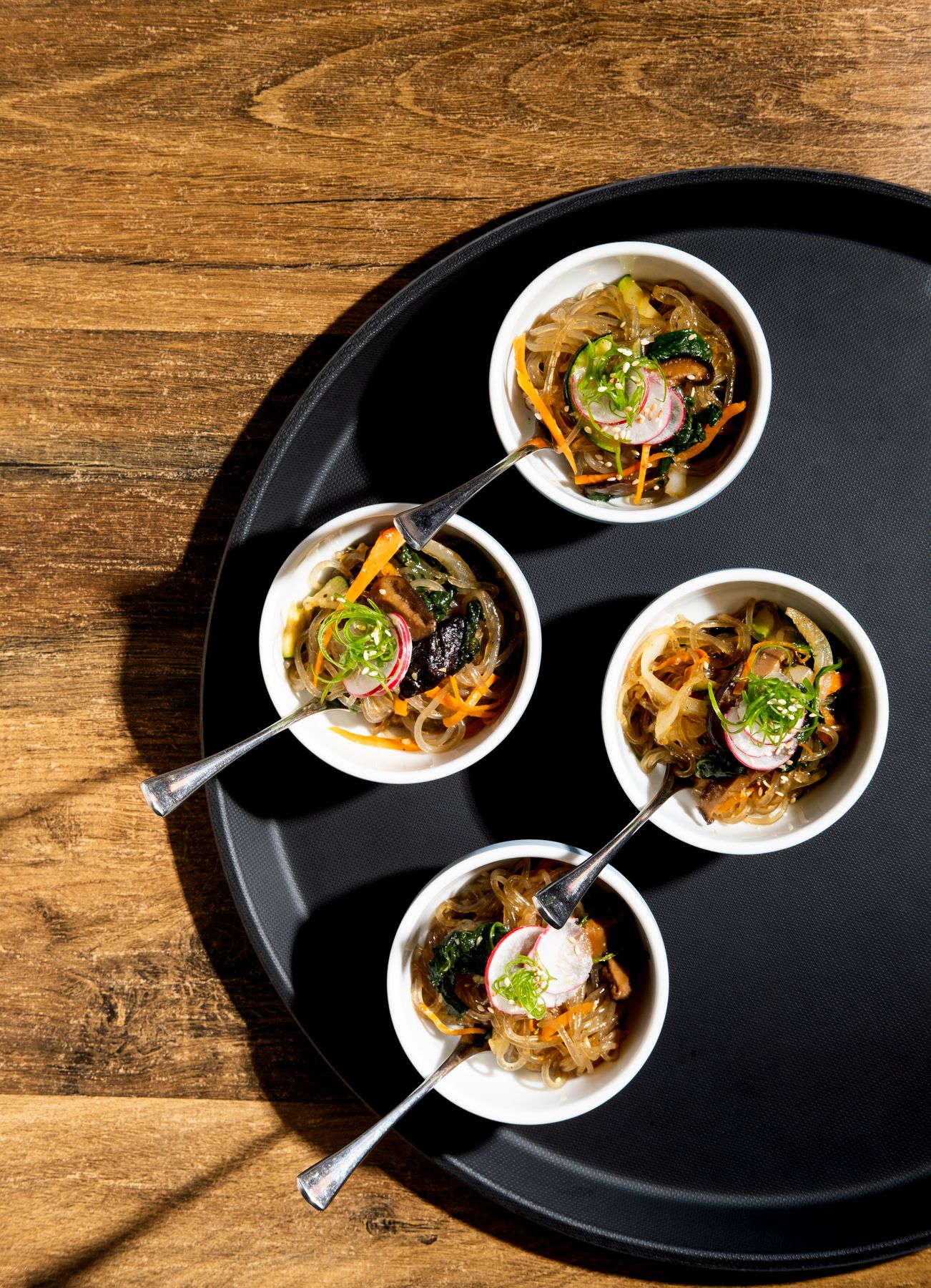 Bowl food served on a black tray