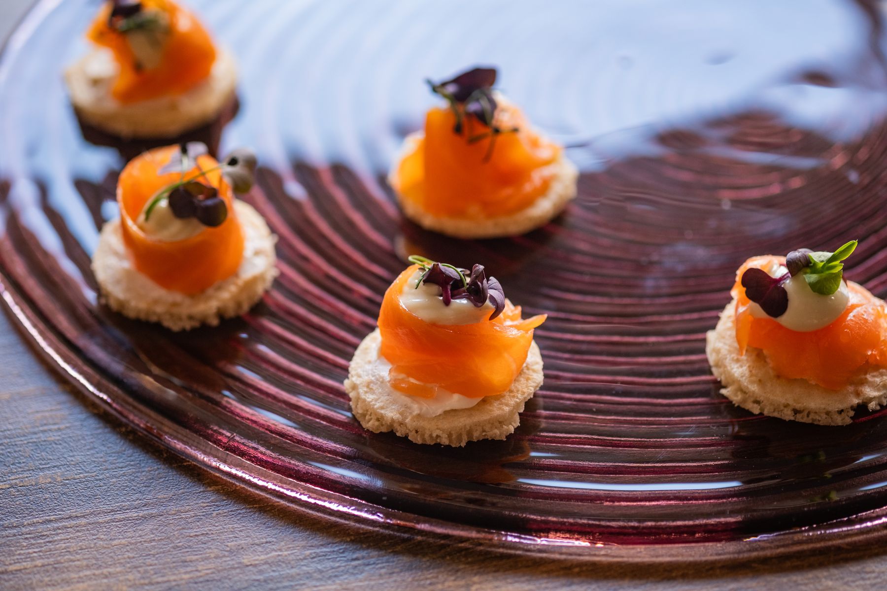 Smoked salmon canapés on a lacquered plate