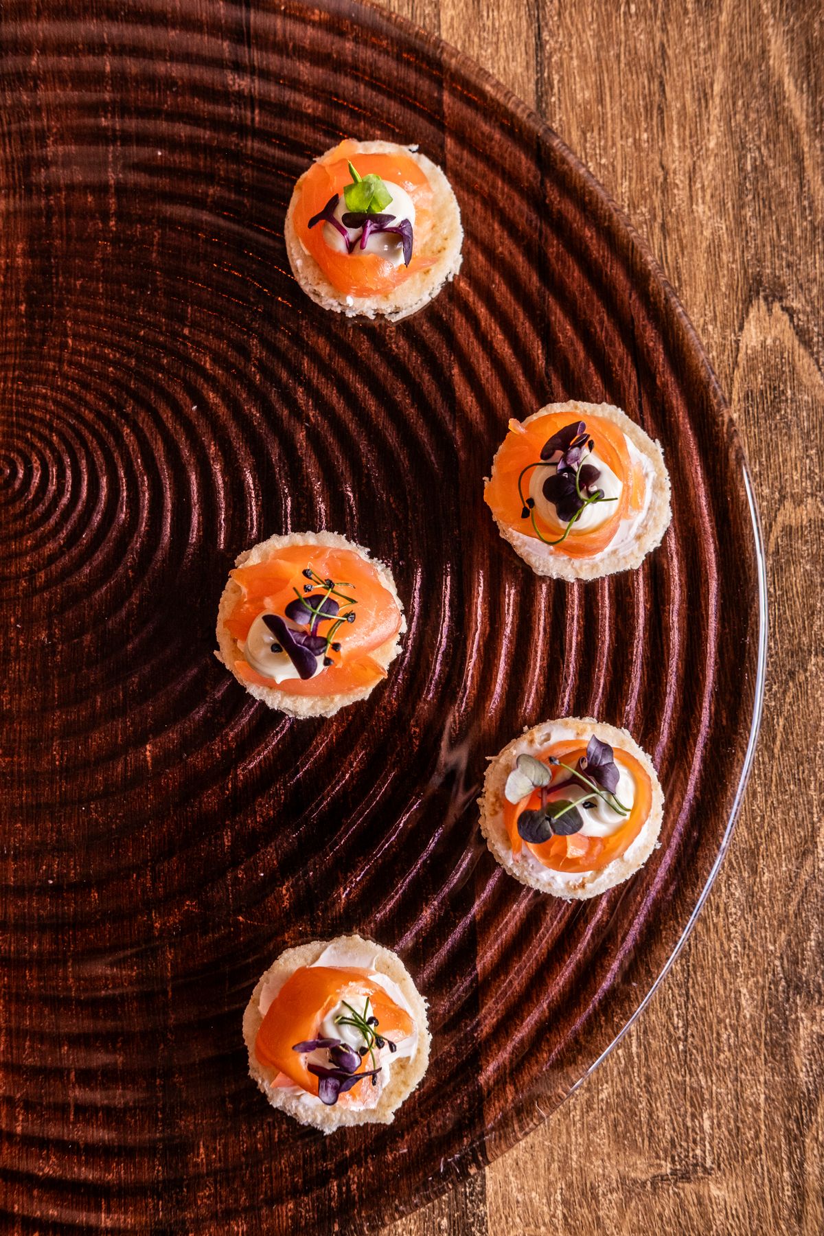 Salmon canapés on a lacquered tray