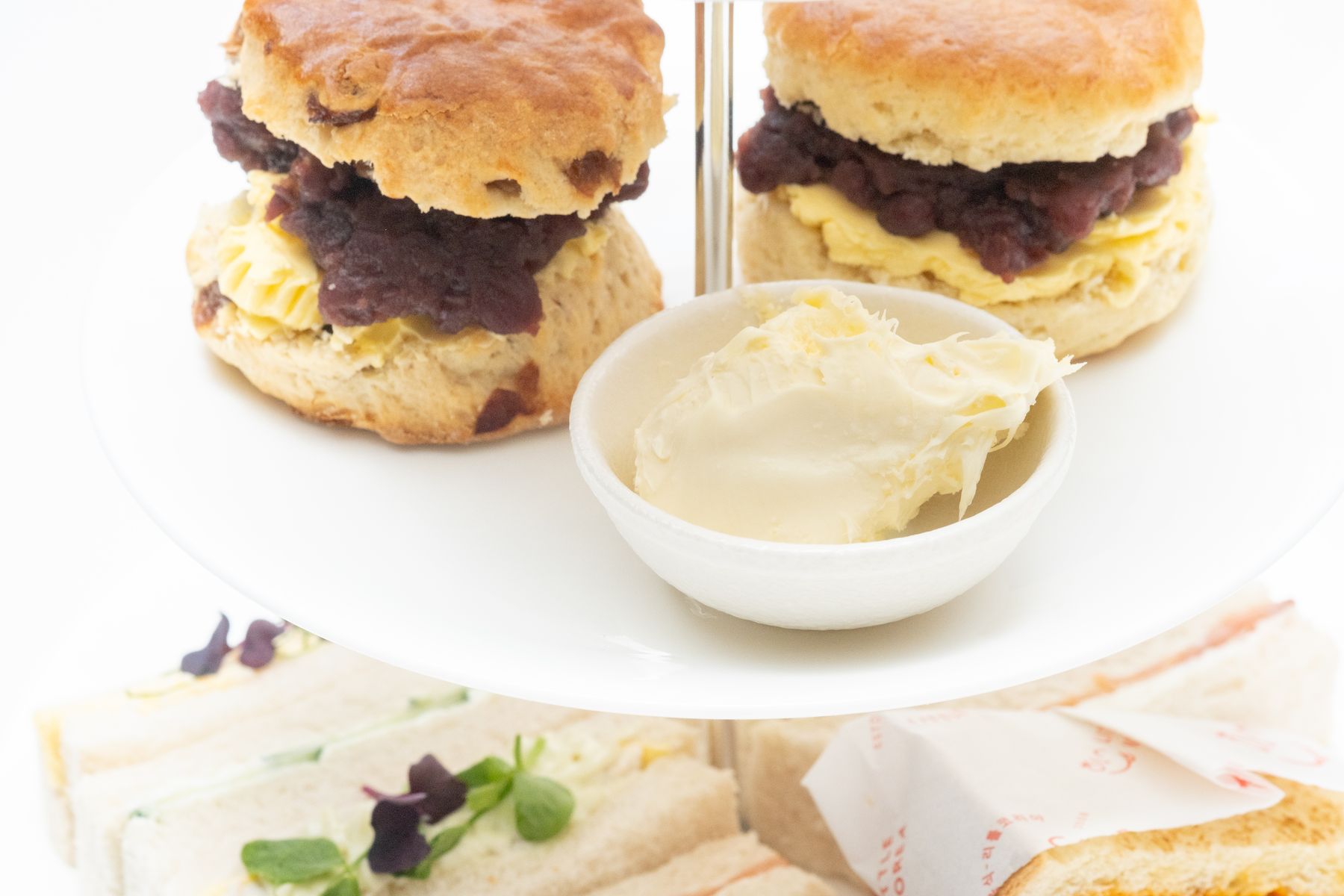 Ang-butter scones and sandwiches on an afternoon tea stand