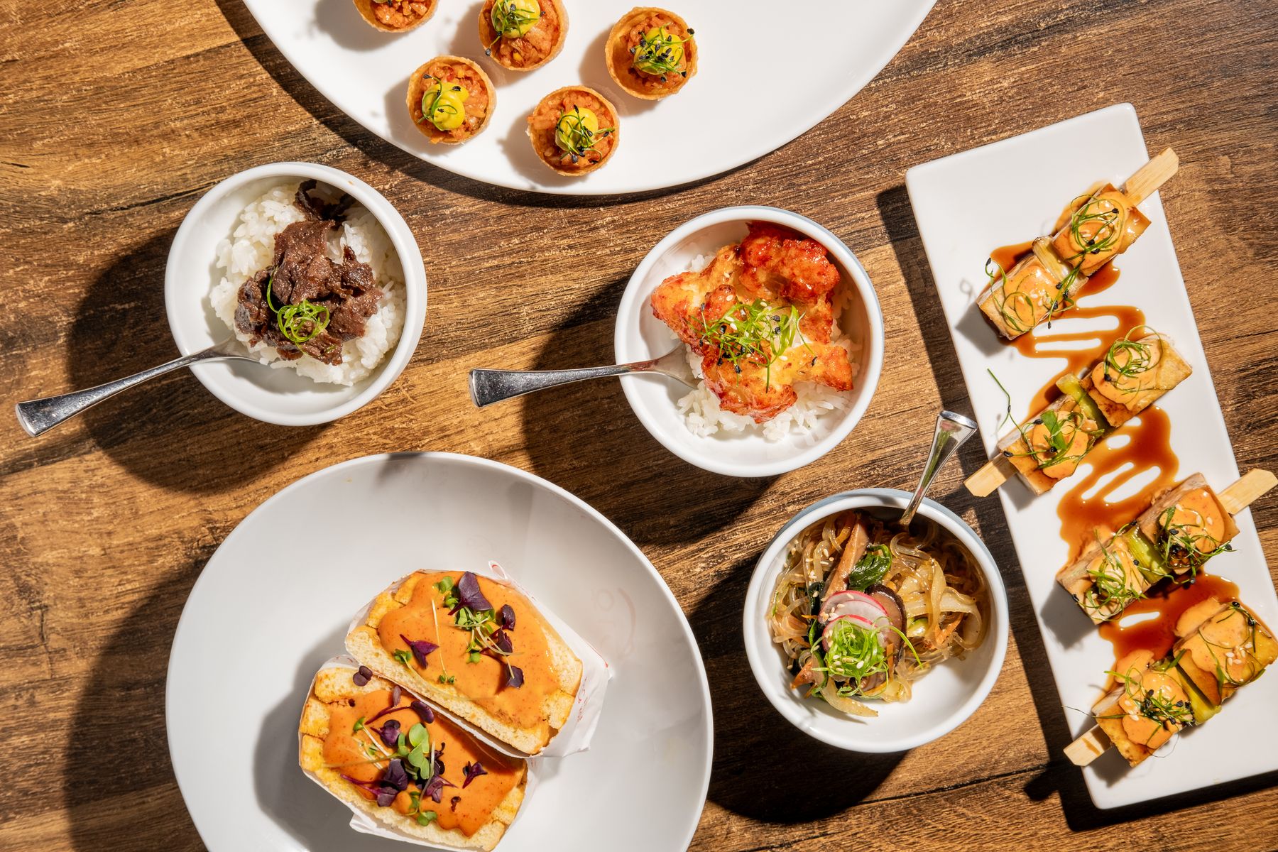 Overhead spread of canapés, bowls and skewers